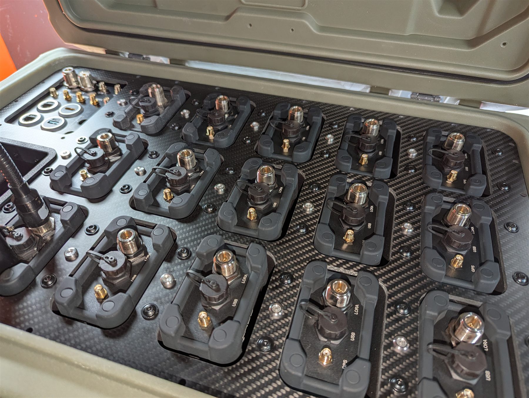 Production Response Crate open with fifteen RM-2 radios seated in their charging cradles
